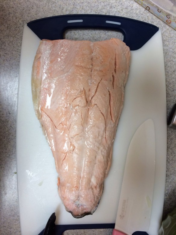 Poached salmon cooling on cutting board